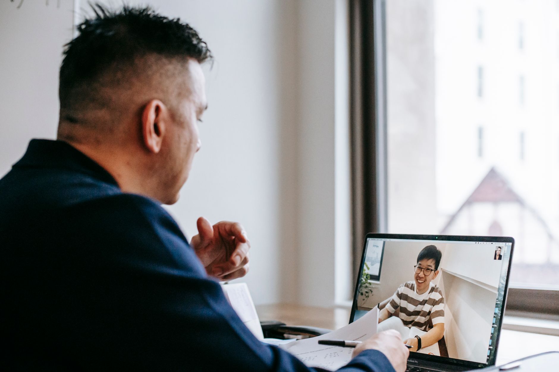 Professional video call between colleagues in an office setting, fostering connection and collaboration.